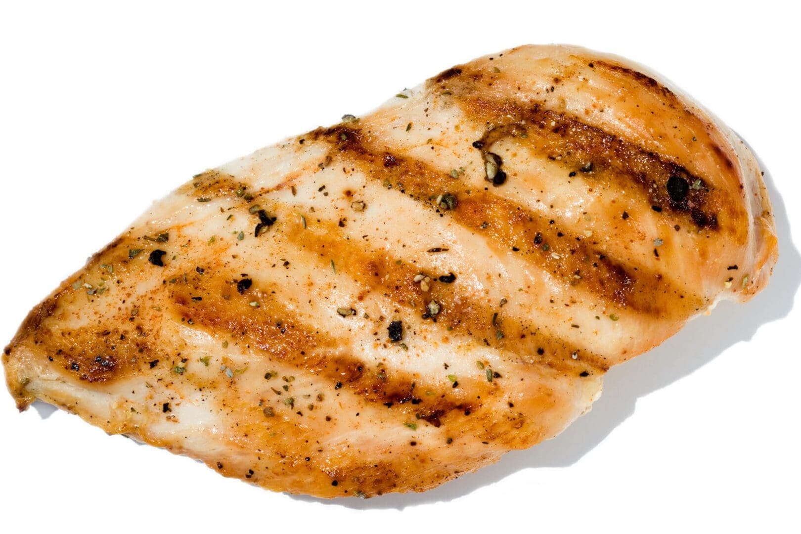 A grilled chicken breast with some seasoning on it