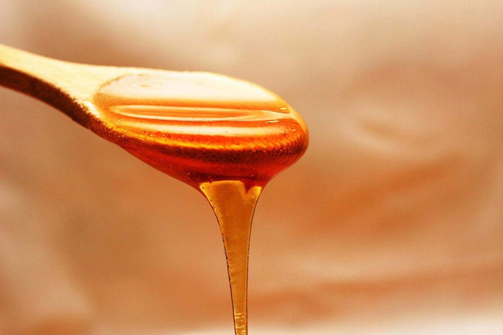 A spoon with honey on it