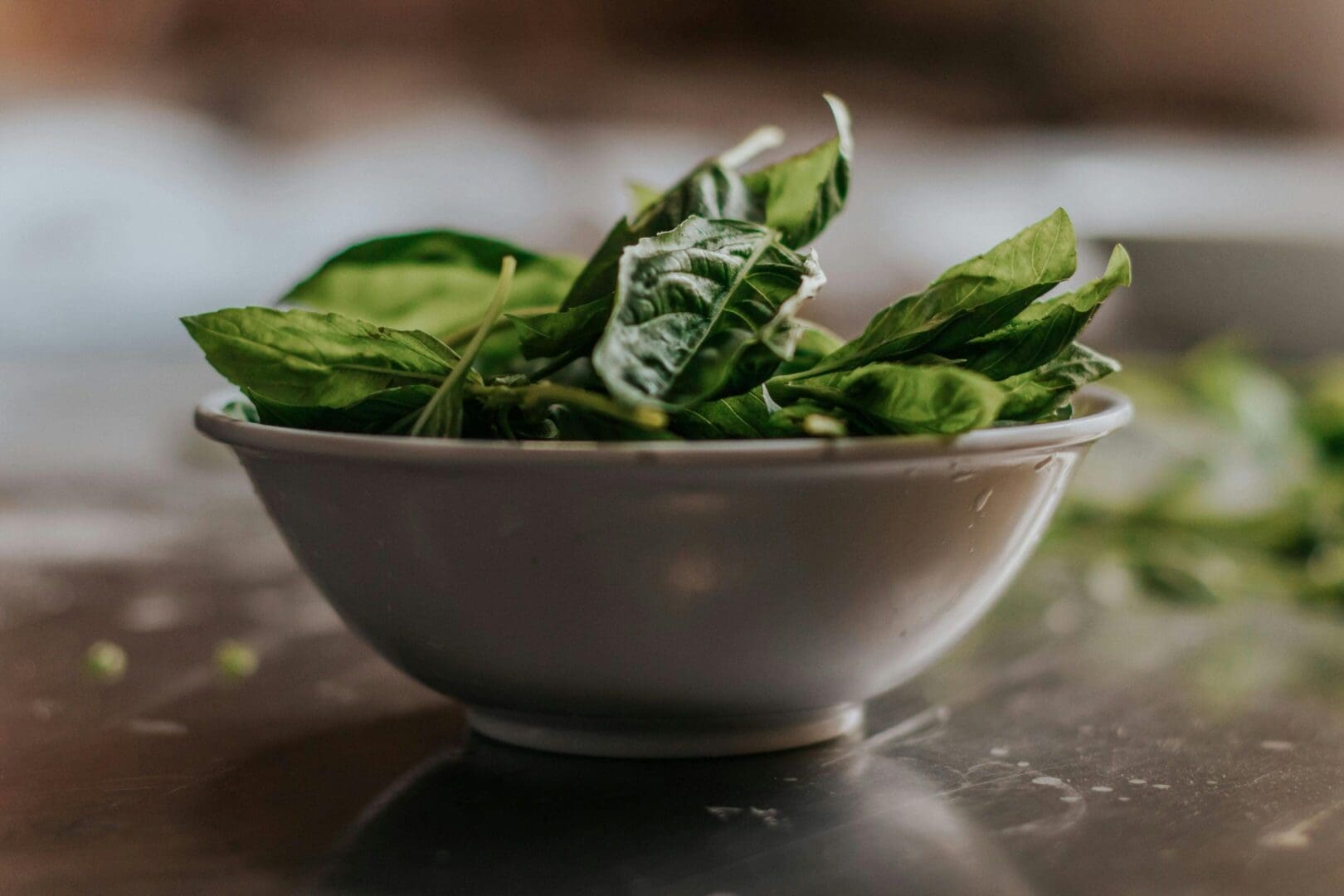 A bowl of spinach on the table