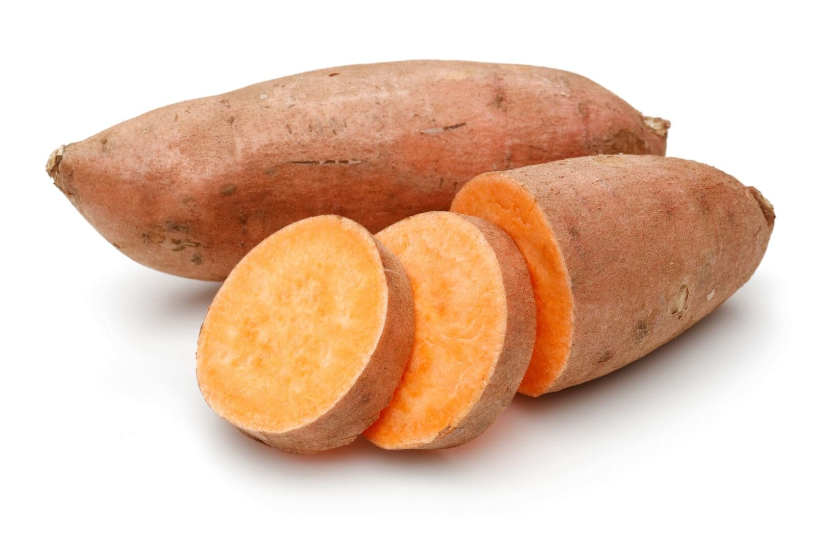 A couple of sweet potatoes are sitting on the table